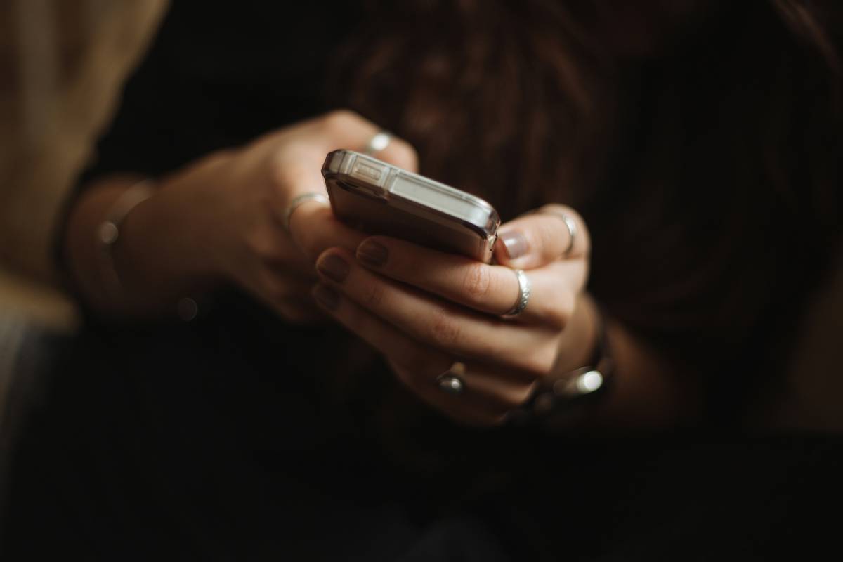 Woman frustrated after losing track of time playing a casual time killer mobile game on her phone